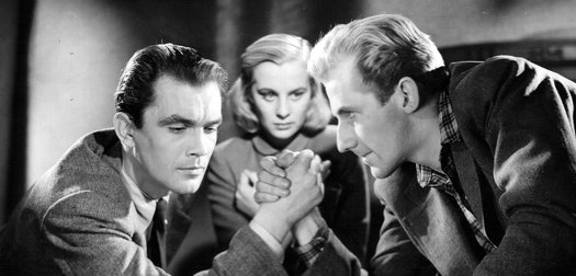 Birger Malmsten  and Bengt Eklund arm wrestle in front of Mai Zetterling in a still from 'Music In Darkness' (1948)