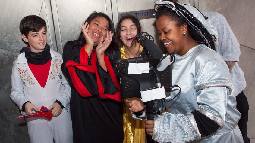 Students in costume playing with a video camera - photo by Mark Gambino