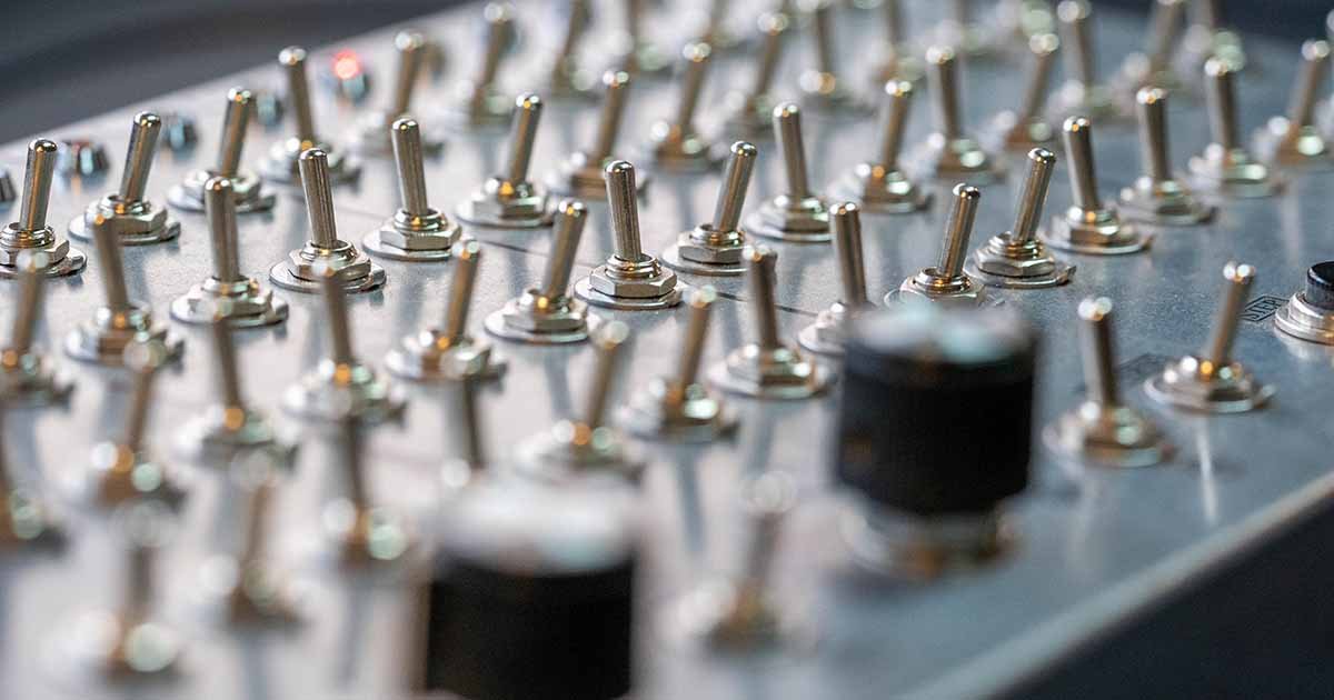 ACMI + MESS Partnership - silver switches on a soundboard