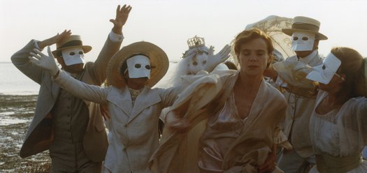 Stina Ekblad in a white nightgown surrounded by figures in white Venetian masks in a still from Amorosa (1985)