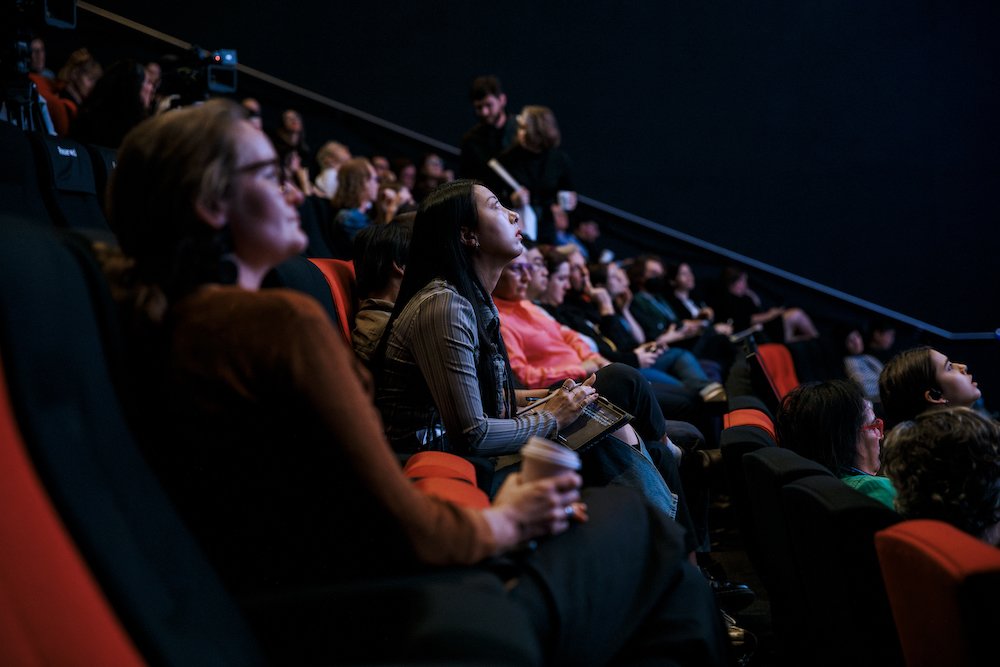 Audience in ACMI cinema listens attentively