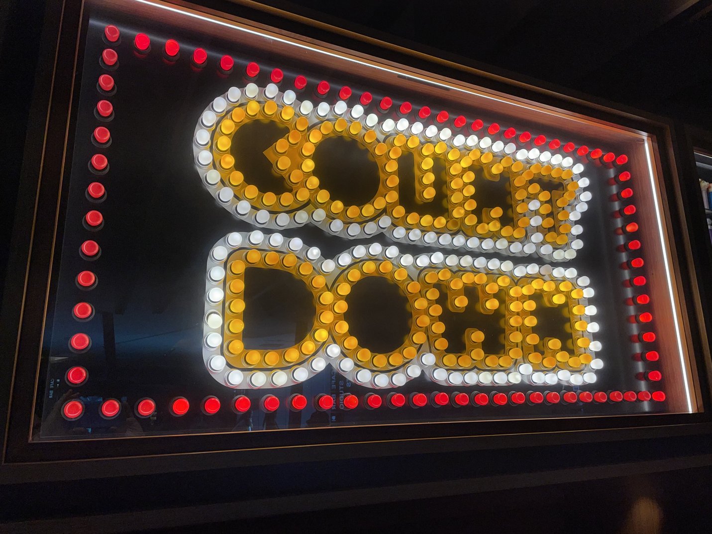 Countdown sign made out of red, white and yellow light bulbs