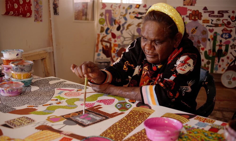 Kaylene Whiskey painting in her studio