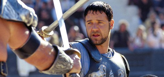 Russell Crowe fights in the colosseum in Gladiator (2000) - hero image