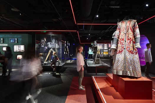 A visitor looks at The Last Emperor costumes in The Story of the Moving Image - photo by Shannon McGrath