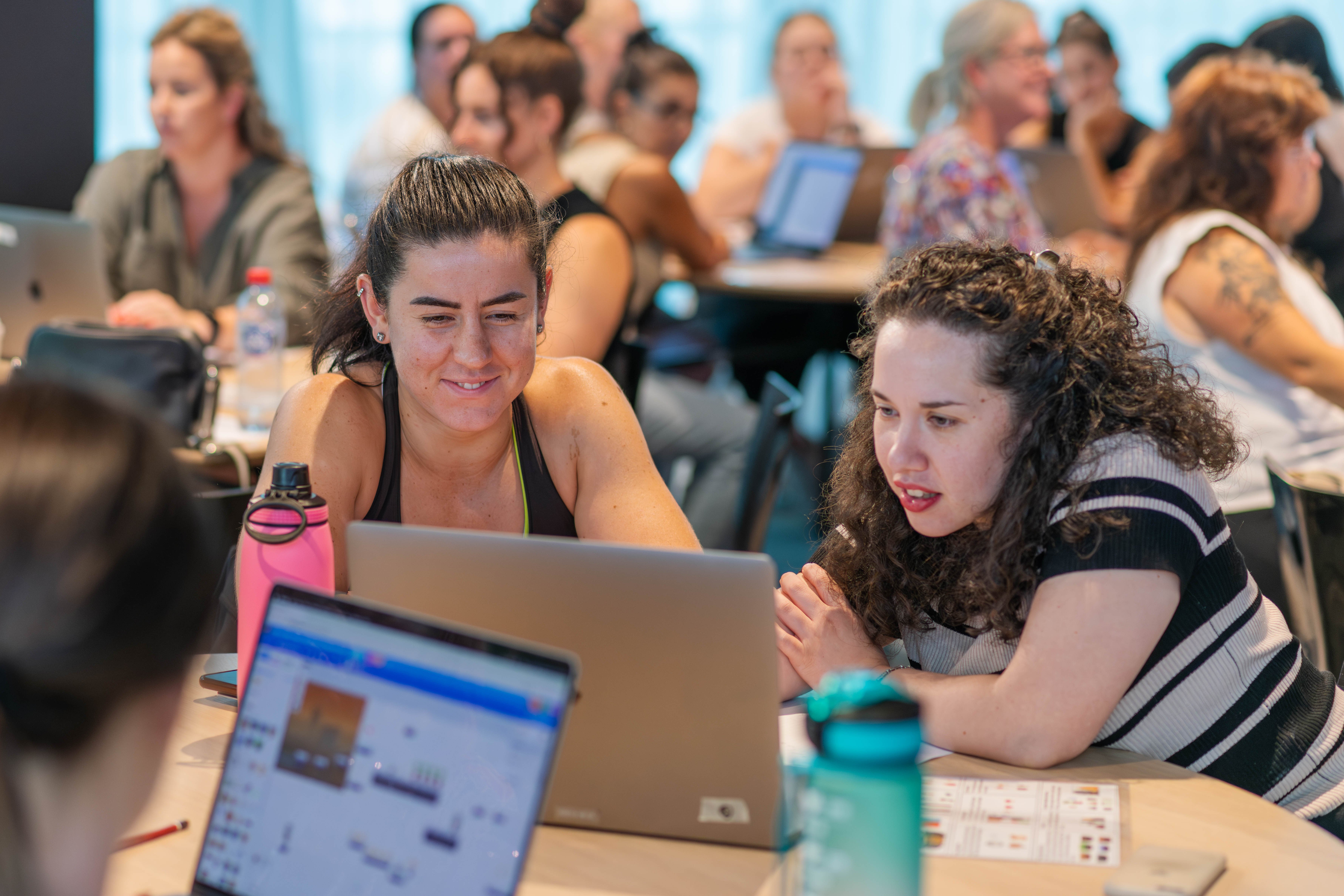 Teachers work together at a computer