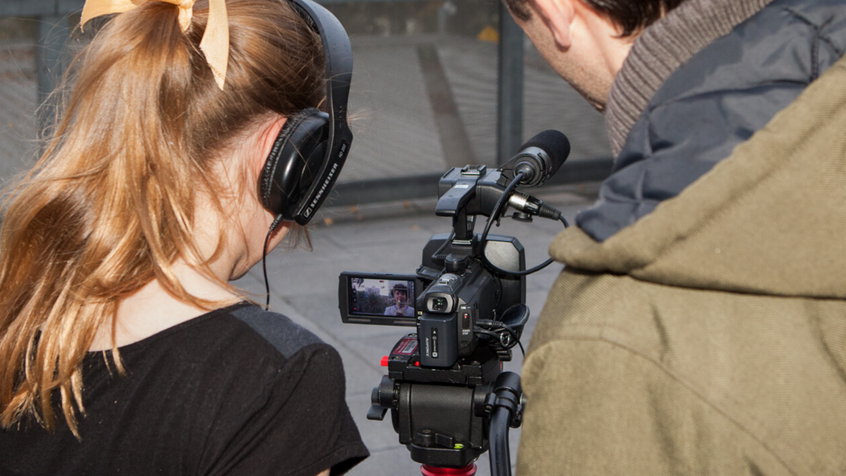 Students filming camera secondary behind 2160 x 1023
