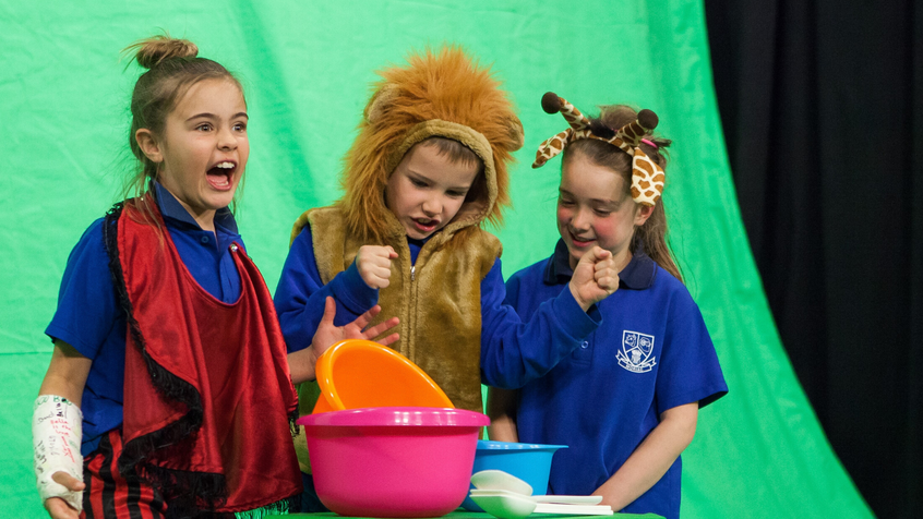 Kids in costumes participating in a green screen workshop at ACMI
