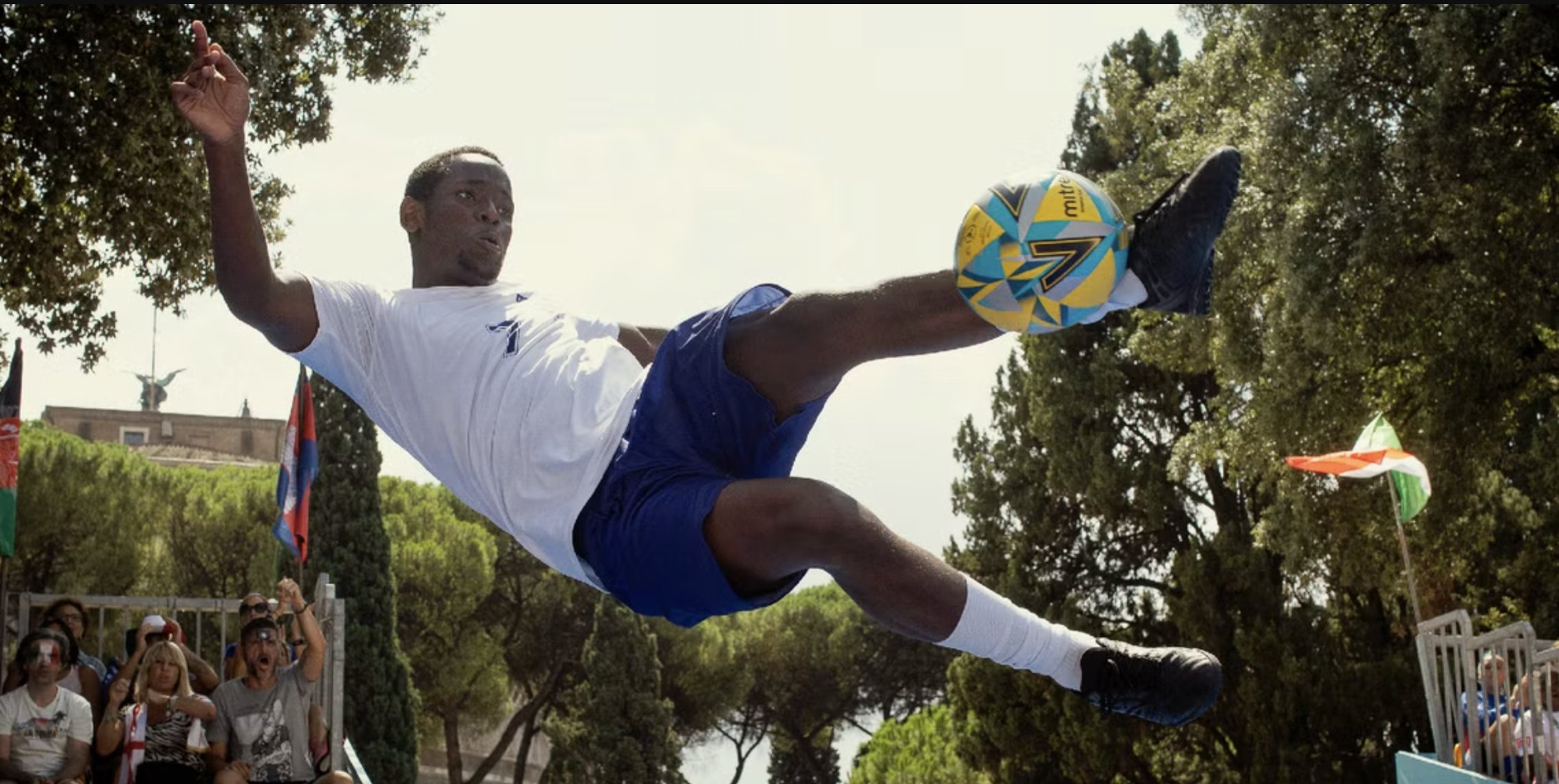 Soccer player flies high as he kicks ball