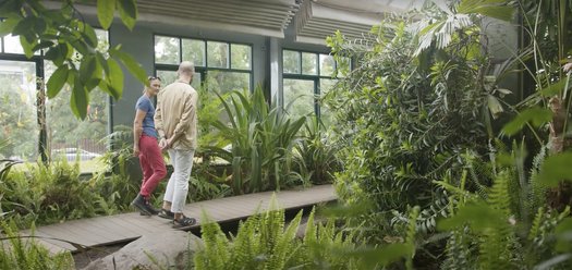 Tully Arnot and Monica Gagliano walking inside an arboretum