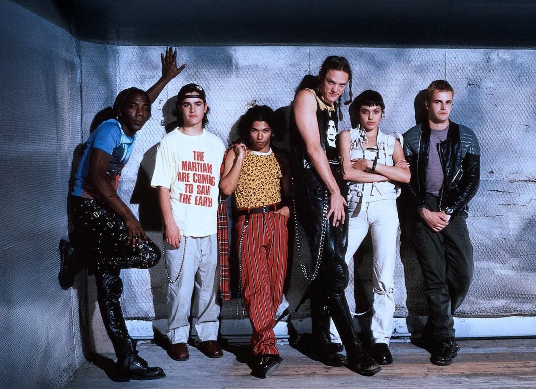 A photograph of the lead characters from the movie Hackers leaning up against a wall.