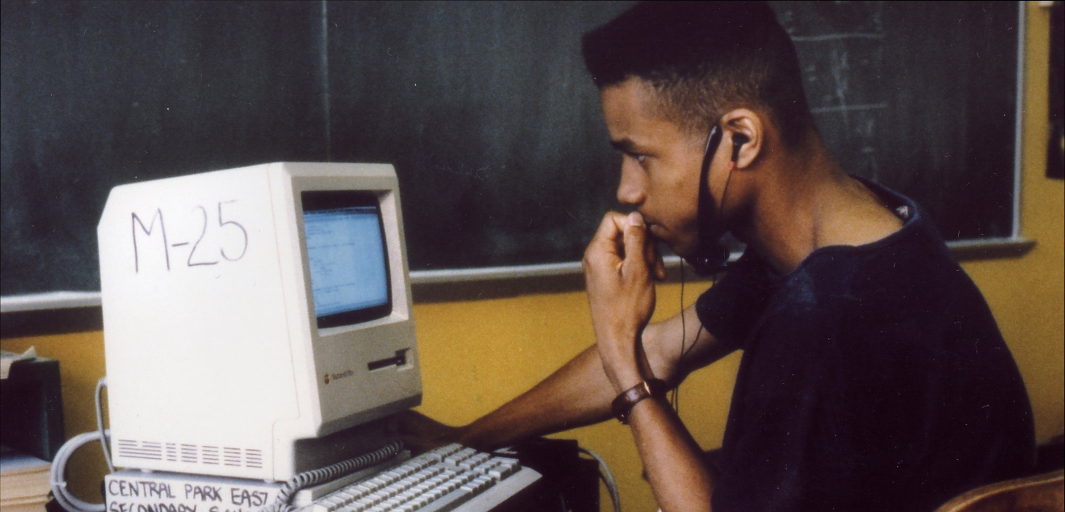 A young African-American student looks intently at a computer screen in a still from 'High School II' (1994) Zipporah Films, Inc.