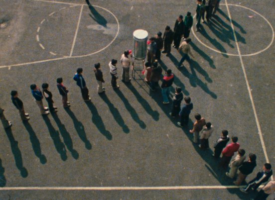 Overhead shot of kids lining up on a school bastketball court in a still from 'Orderly or Disorderly' (1981) (c) Kanoon