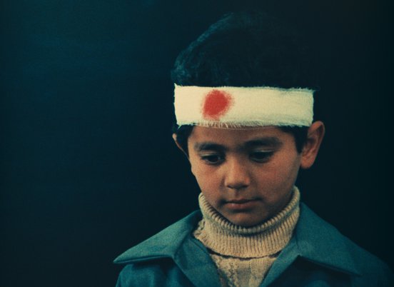 Kid wearing a headband with a red spot on it in a still from 'Two Solutions For One Problem' (1975) (c) Kanoon