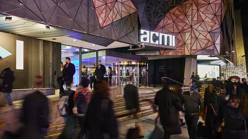 Crowds of people at the entrance to ACMI during the evening.