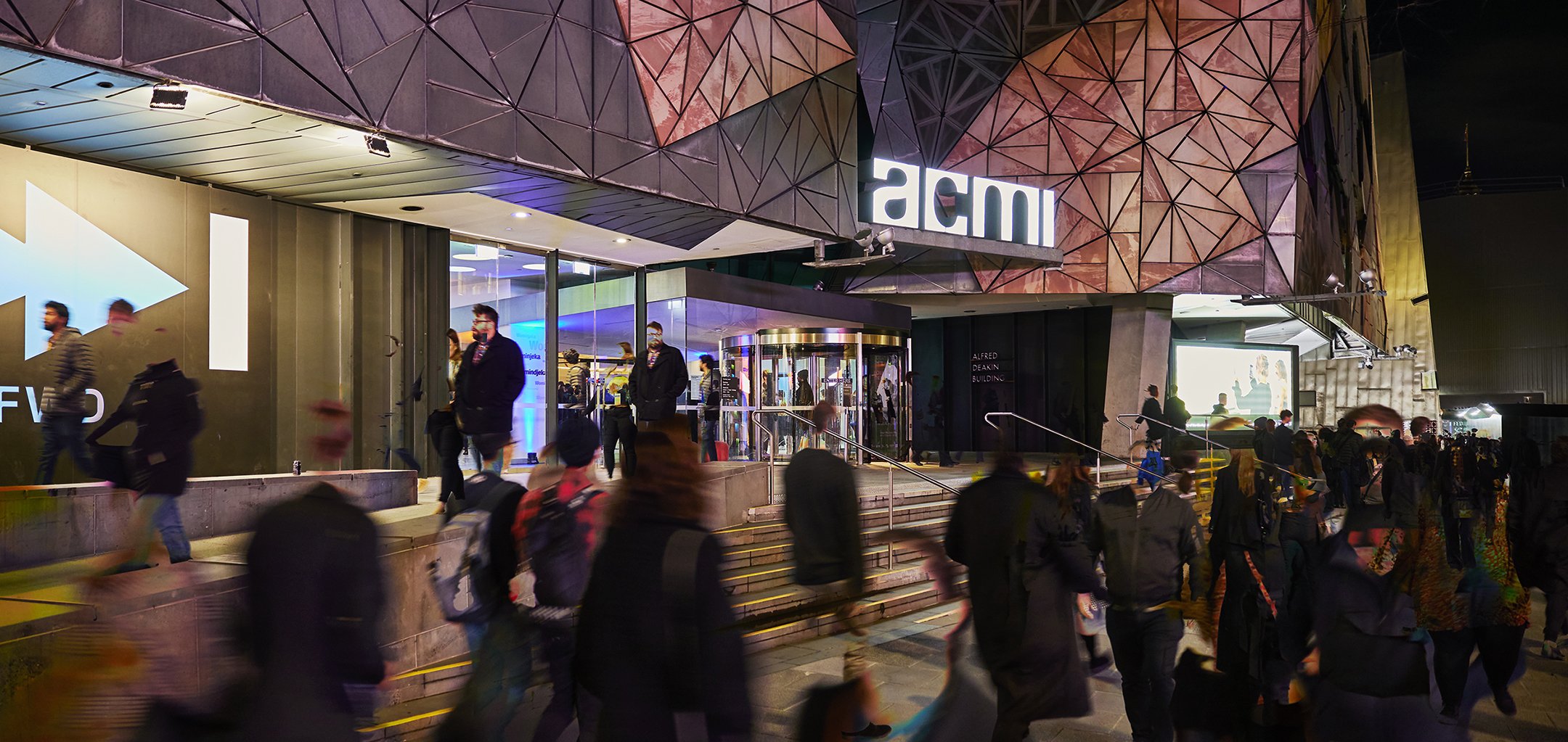 Crowds of people at the entrance to ACMI during the evening.