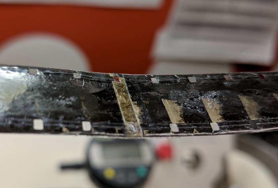 A fragile cement splice reinforced with splicing tape. Evidence of crystalline deposits forming to the right of the splice.jpeg