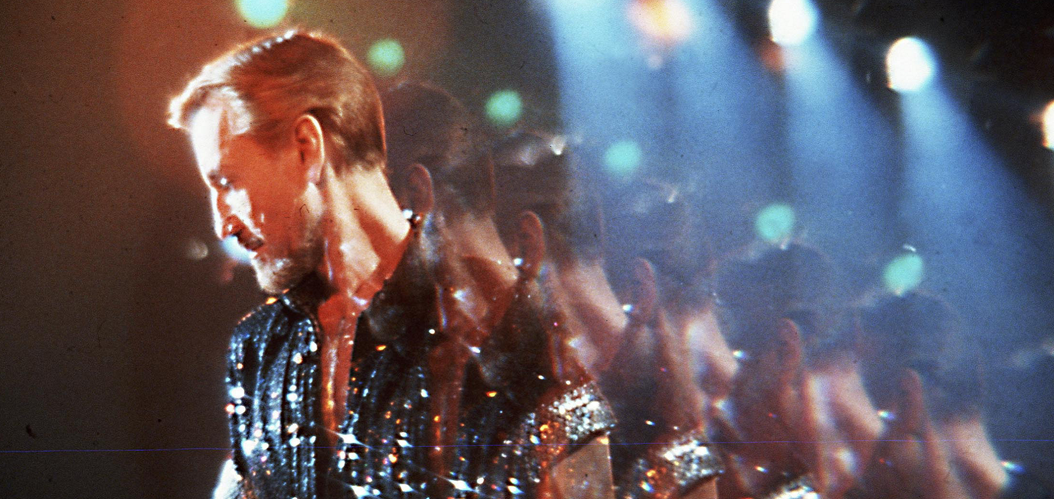 A side profile mirror image shot of Roy Scheider wearing a shiny, sequined shirt in a still from 'All That Jazz' (1979)