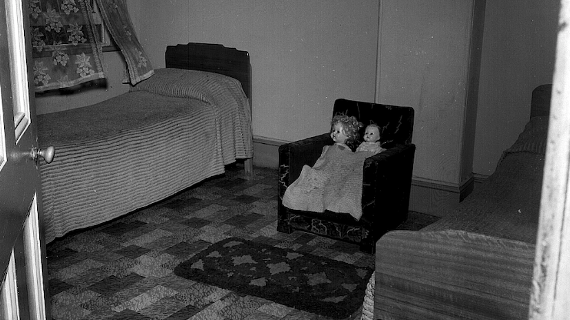 Cropped still from Spirit_Patrol - dolls in a tiny armchair