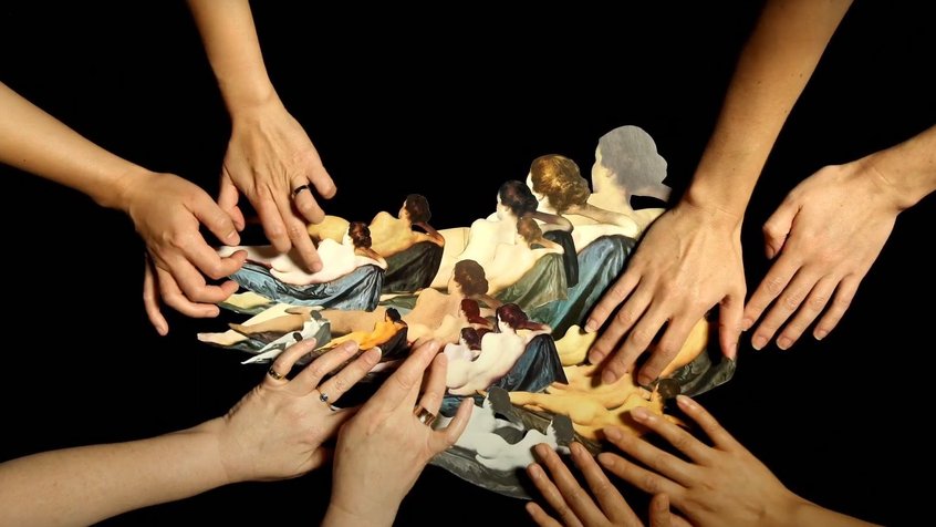 Many hands working on collage work in a still from Deborah Kelly's The Gods of Tiny Things (2021)