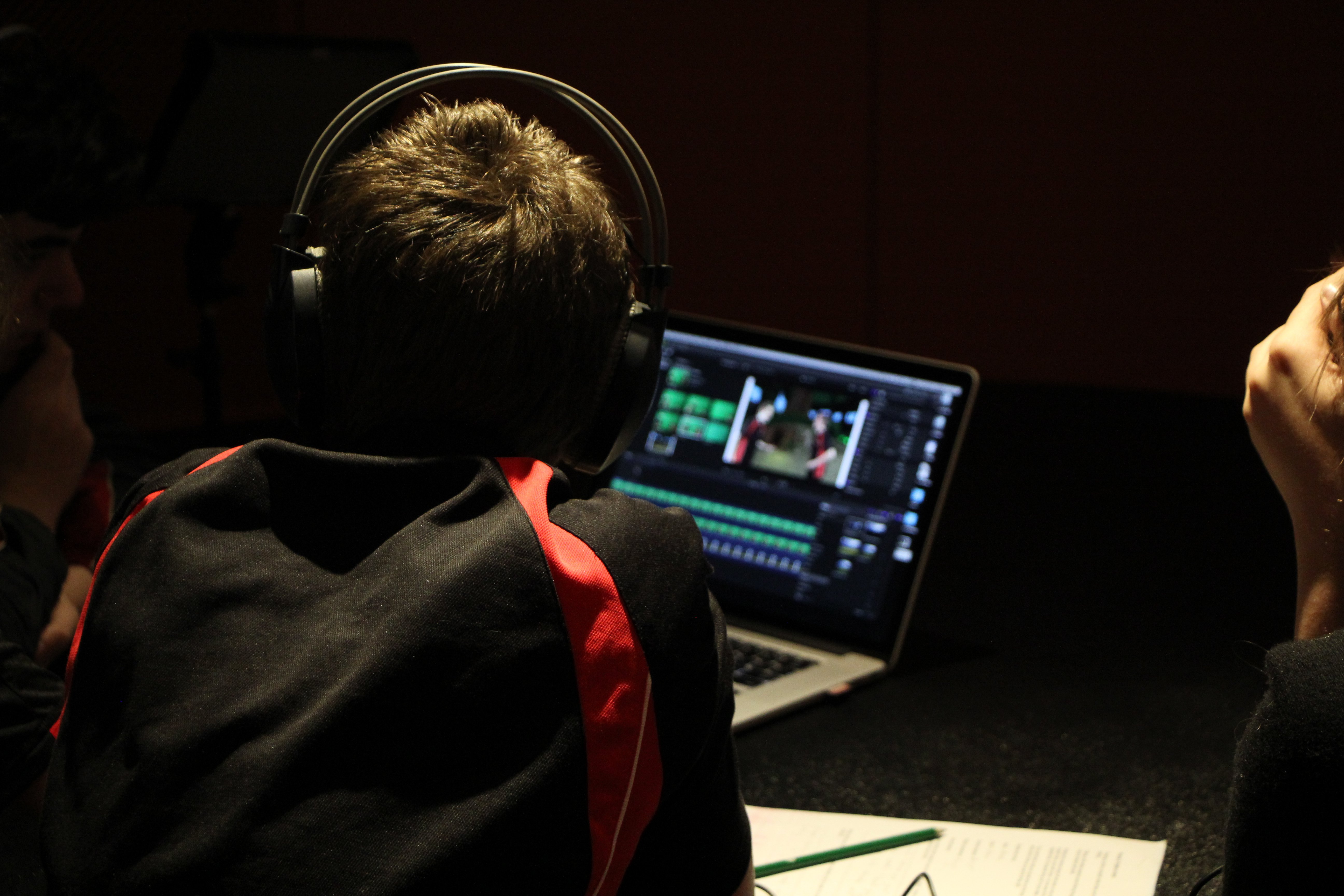 Students editing together on a laptop