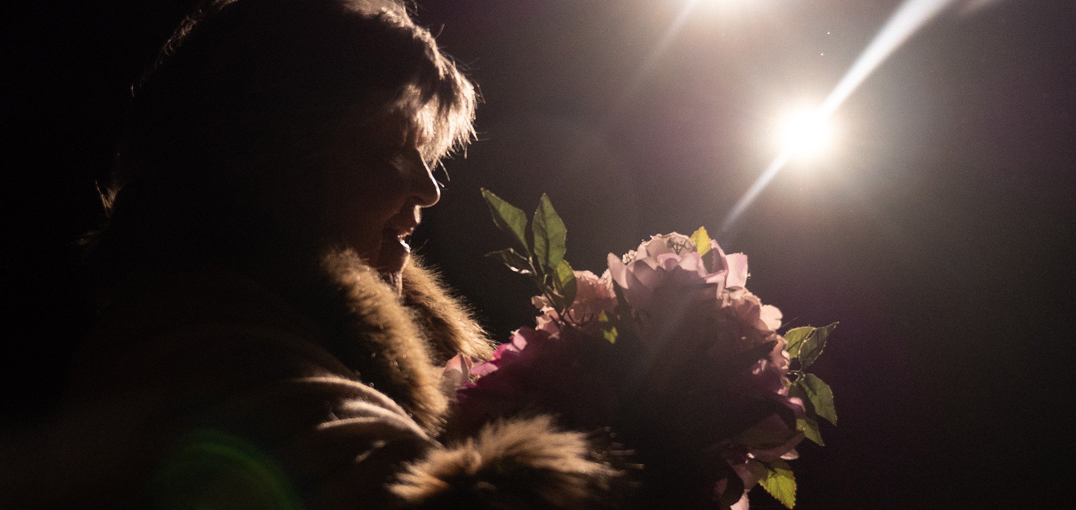 A still from Laura's Choice - holding flowers
