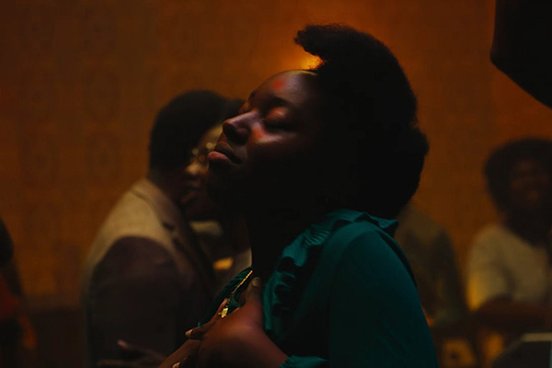 A still of a partygoer dancing from 'Lovers Rock' (2020)