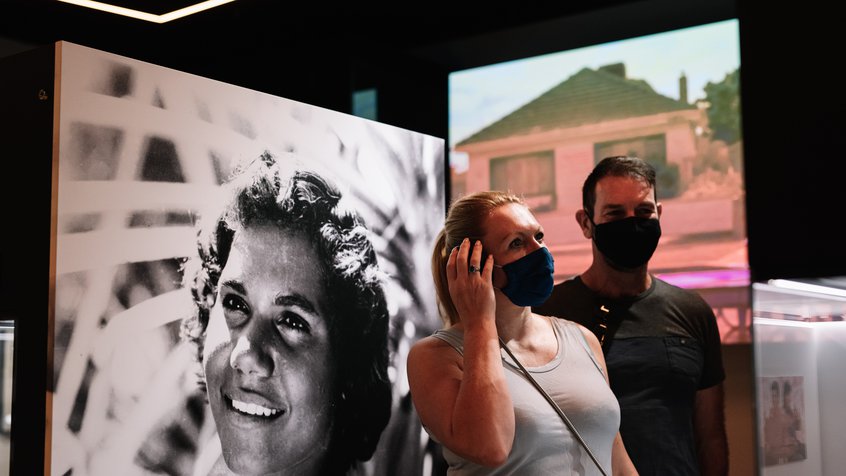 A couple listens to interactive audio in the Moving Australia section of The Story of the Moving Image (image credit: Phoebe Powell)
