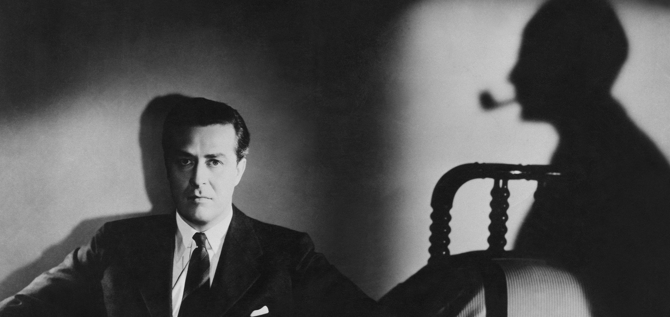 Ray Milland and an ominous shadow smoking a pipe in 'Minstry of Fear' (1944)