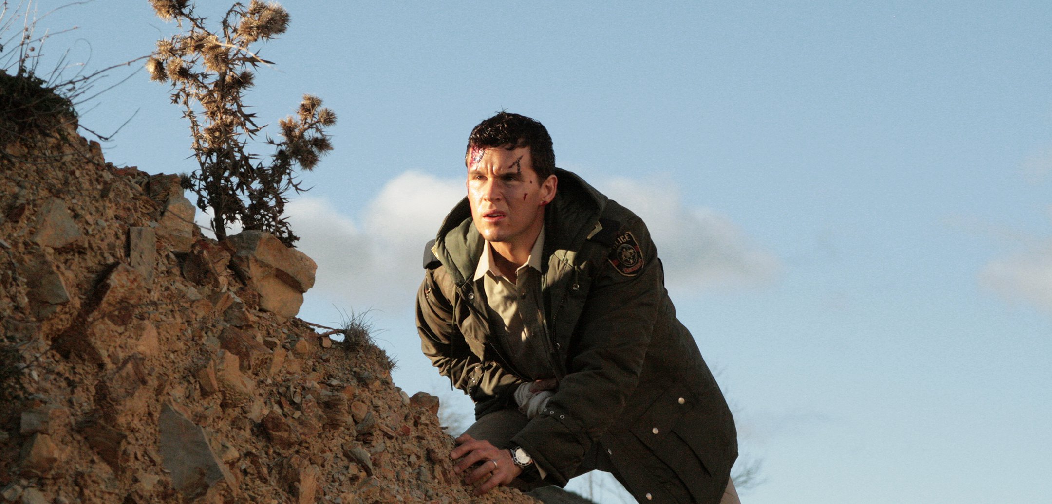 Ryan Kwanten as Shane Cooper, with head injuries ascending a hill in a still from 'Red Hill' (2010)