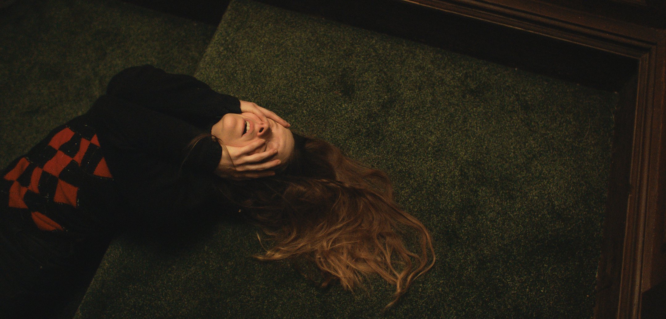 Morfydd Clark writhing in agony in a still from 'Saint Maud' (2019)