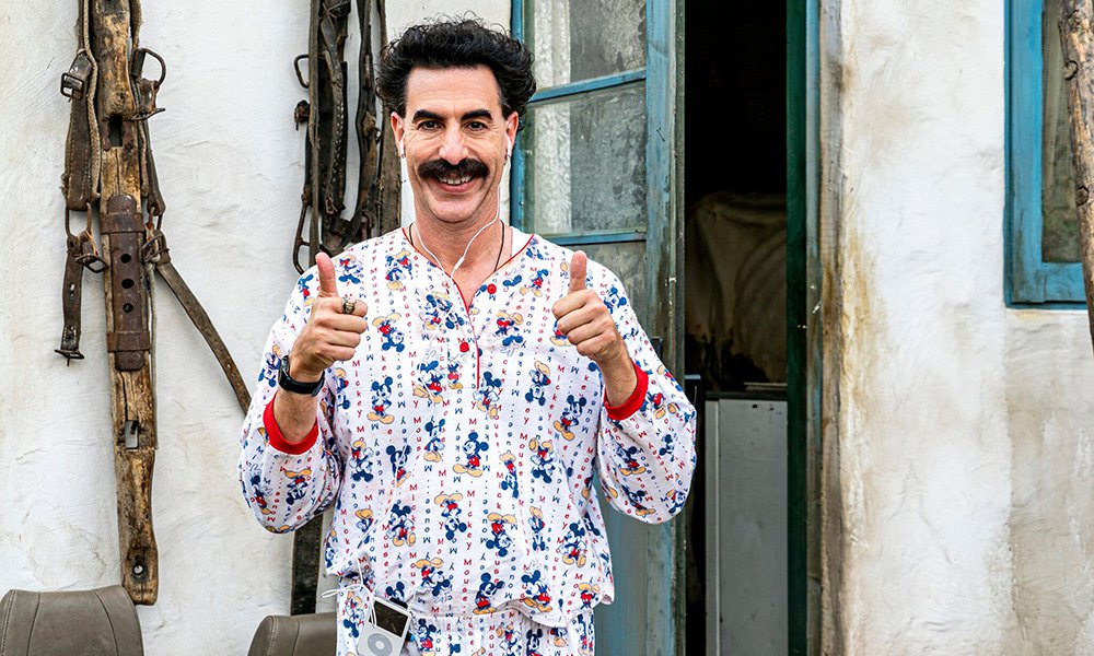 Sasha Baron Cohen as Borat giving the double thumbs up in a still from Borat 2 (2020)