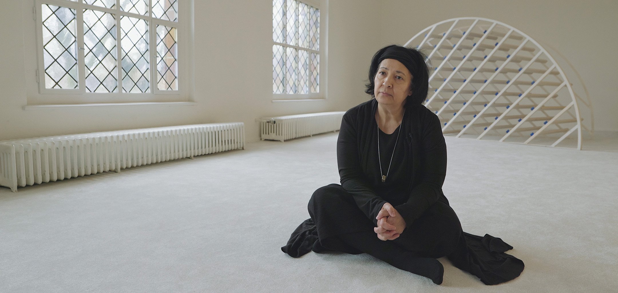 Seyran Ateş sitting on the floor of a mosque