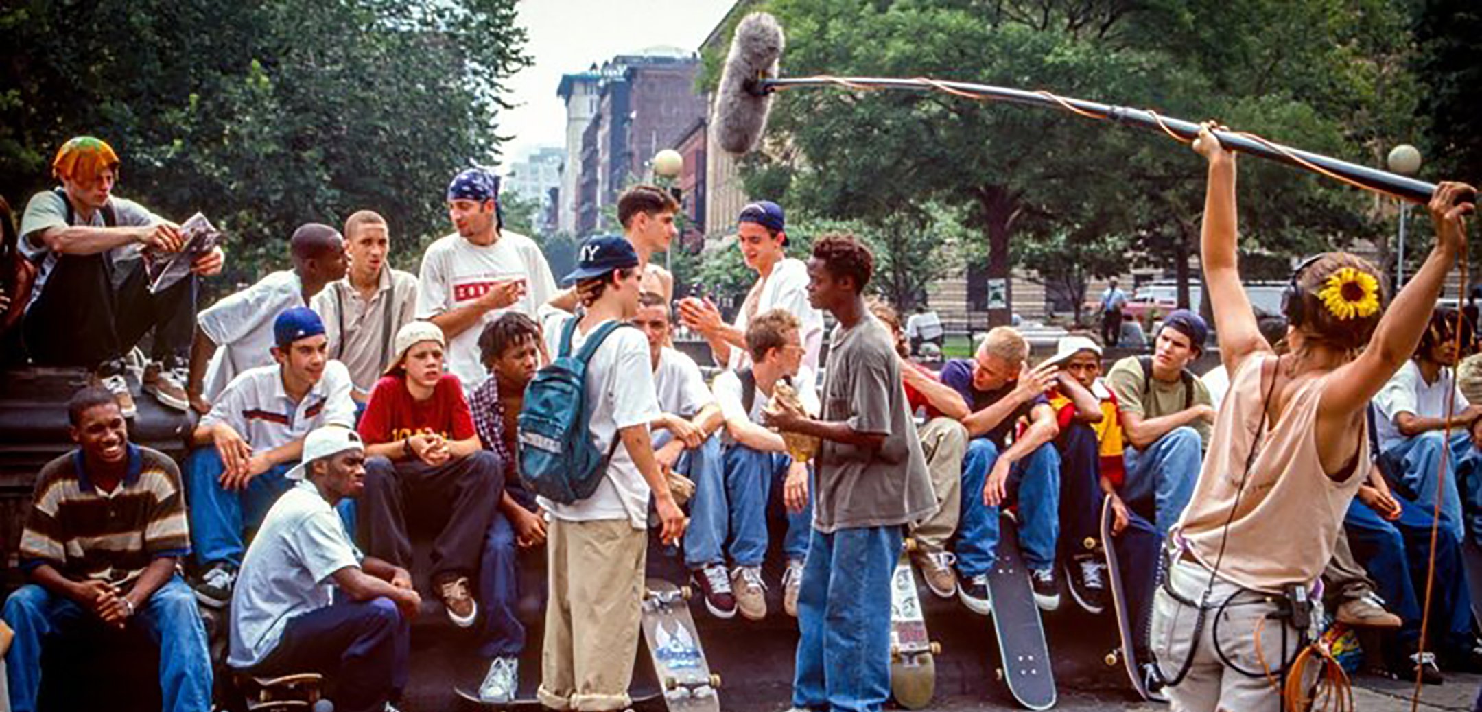 An array of US teenagers in the 90s wearing skate attire, being filmed. Still from 'We Were Once Kids' (2021)