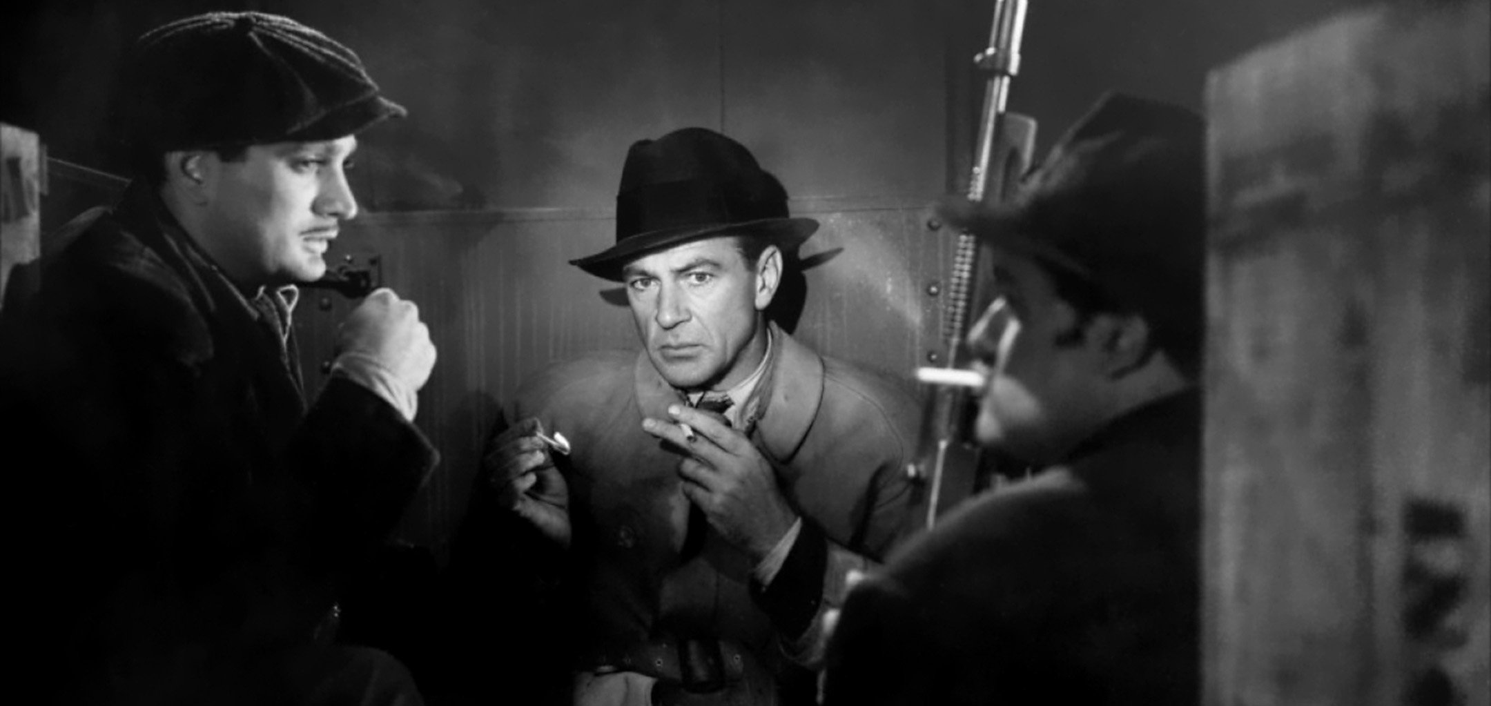 The cast of 'Cloake and Dagger' (1946) having a smoke