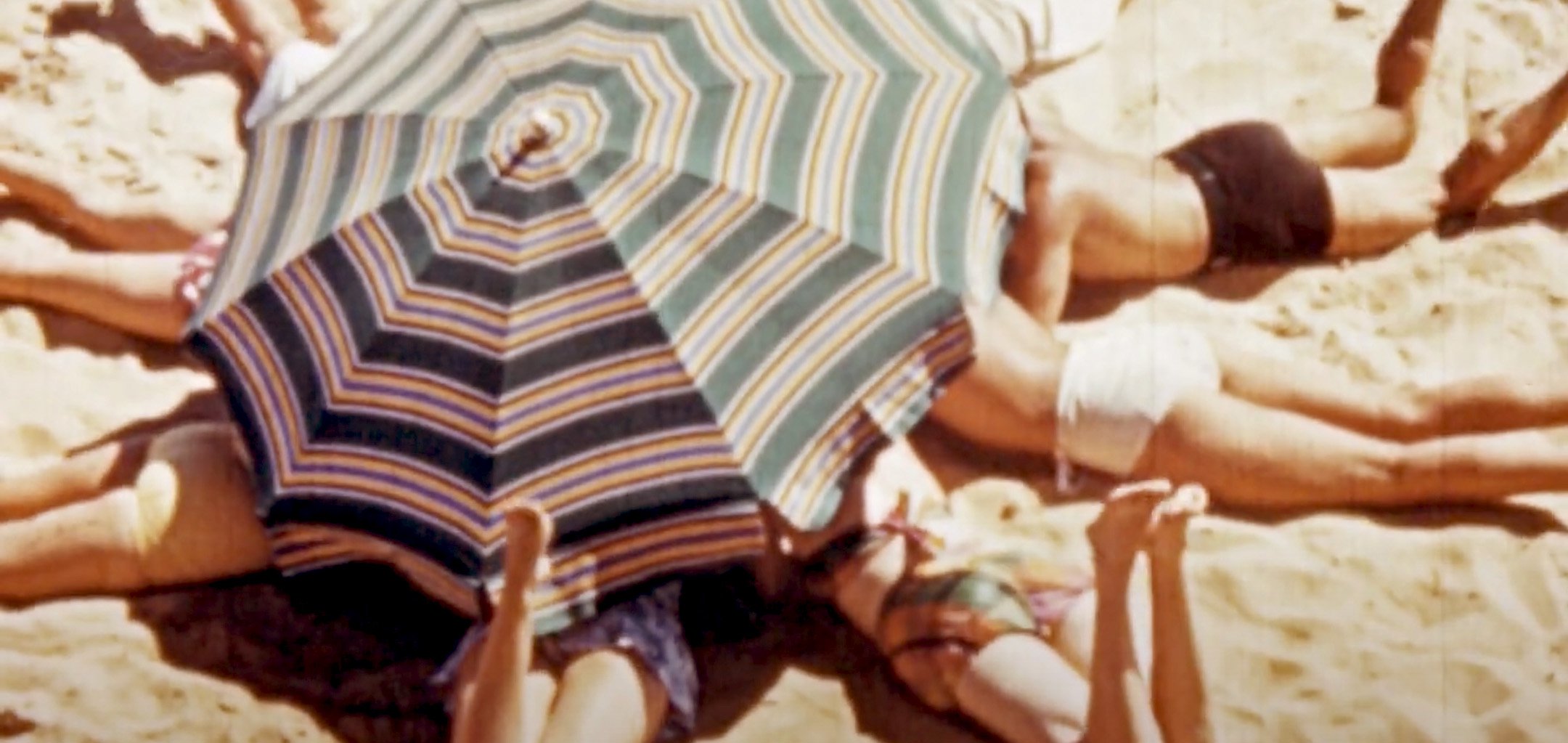 Bush and beach around Melbourne (1952) ACMI Collection - lying under the unmbrella