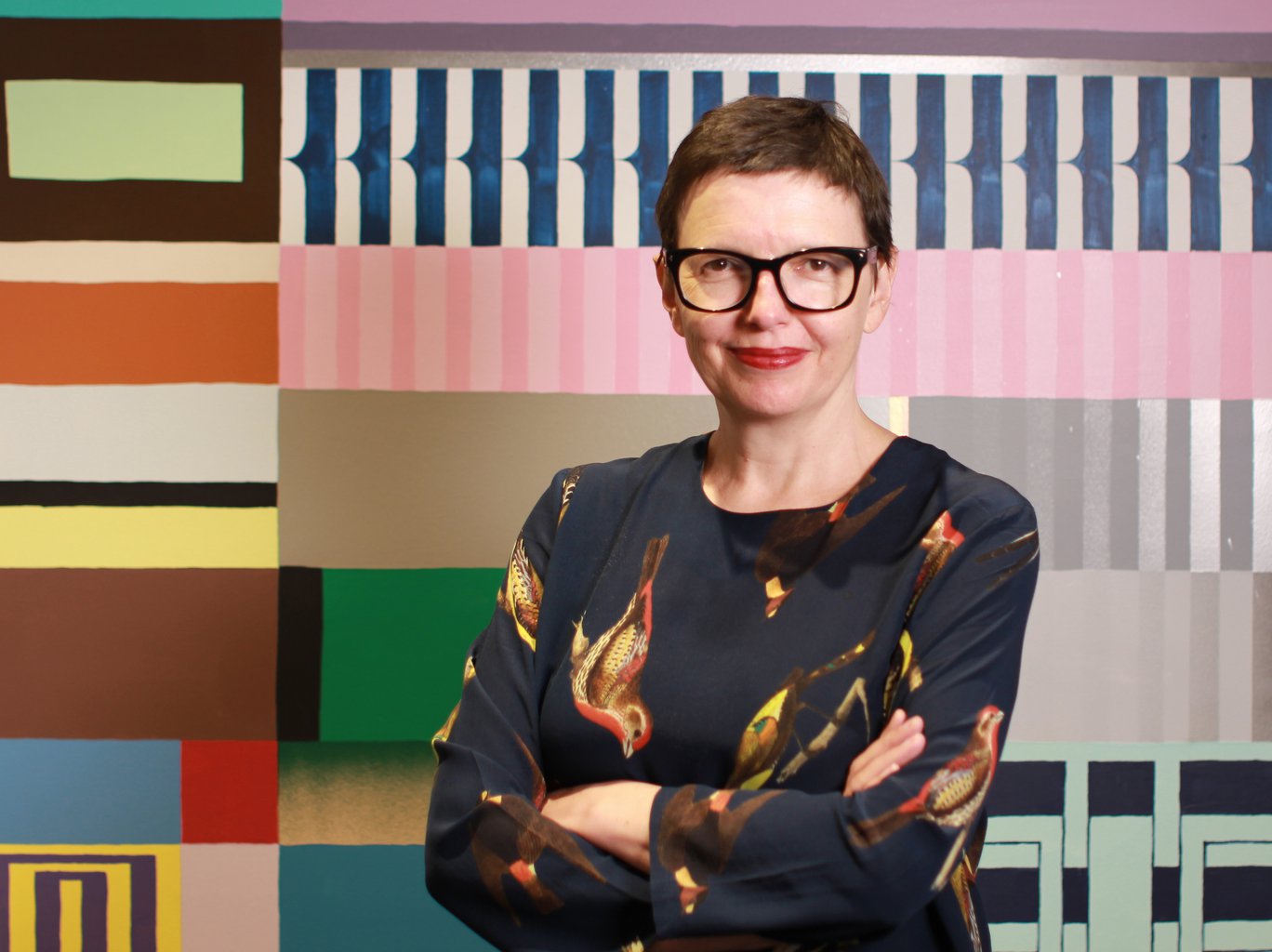 Katrina standing in front of a patterned colourful wall