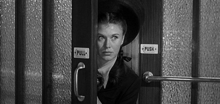 Ginger Rogers peering from behind a door in The Major and the Minor (1942)
