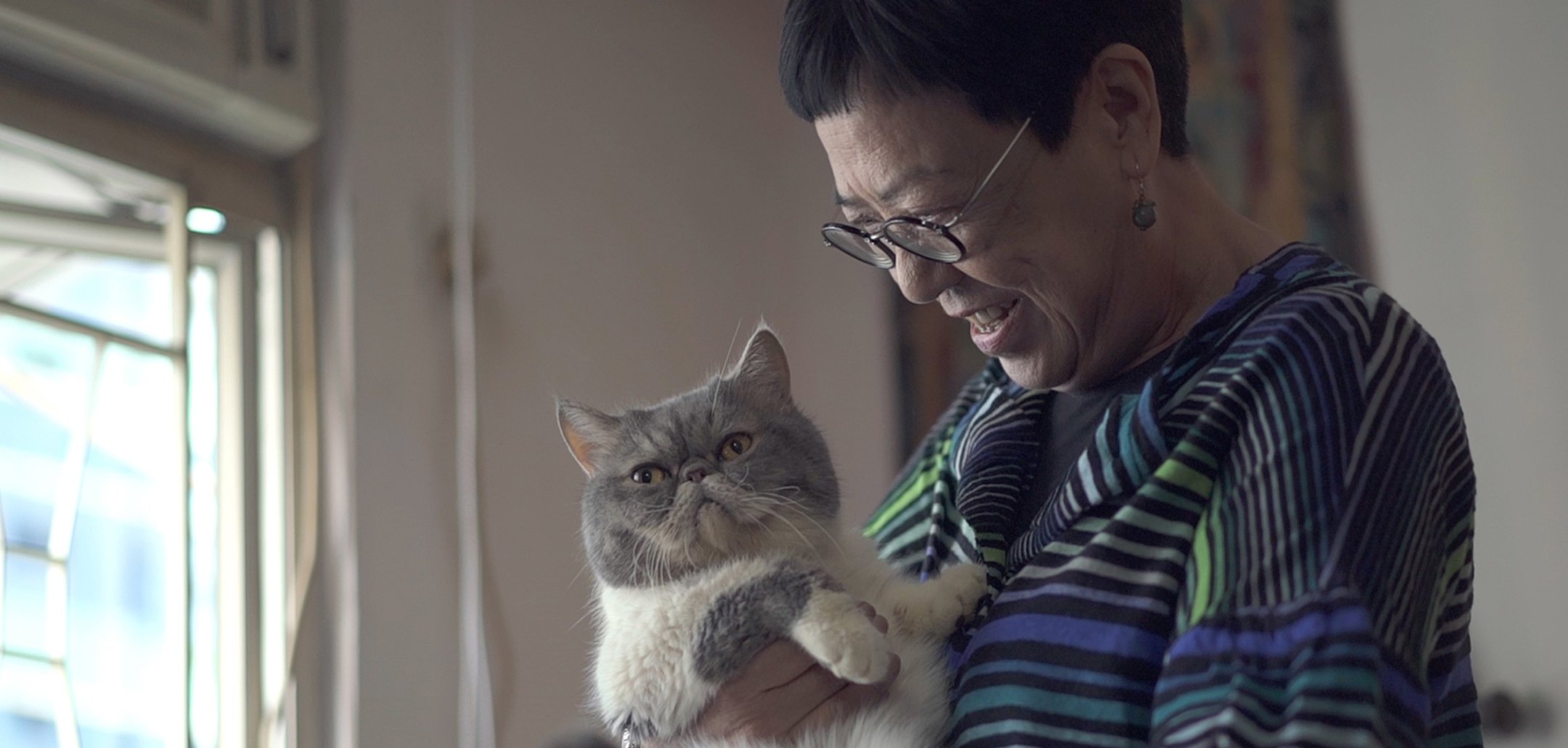 Ann Hui with her cat in a still from 'Keep Rolling' (2020) courtesy of Golden Scene